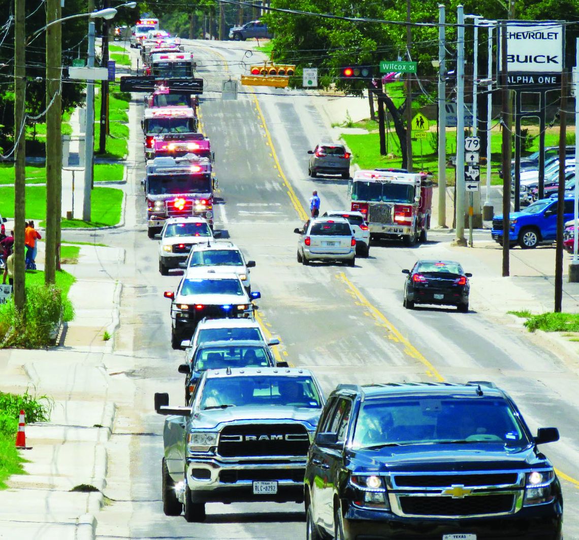 Service vehicles, including fire trucks from the area were a part of the processional for Taylor retired firefighter Robert Whitmore.