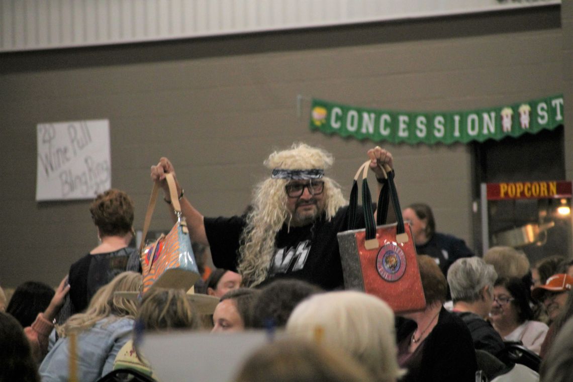 At-large councilman Dwayne Ariola models a purse up for grabs at the Designer Purse Bingo fundraiser Nov. 5 at the Williamson County Expo Center. Photo by Nicole Lessin