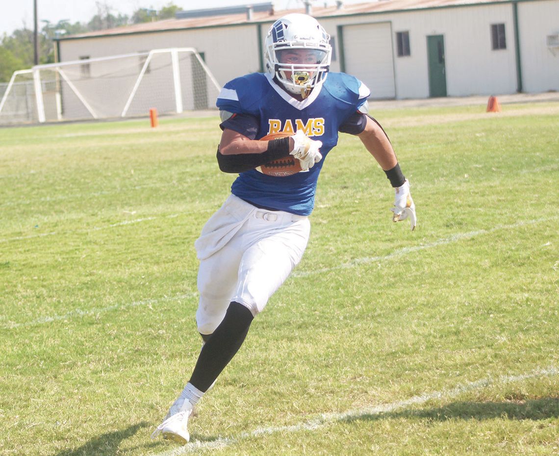 Rams varsity football junior running back Tyler Zimmerhanzel cuts upfield and gains extra yardage on Aug. 26 during St. Mary’s home game vs. Wilco Home School.