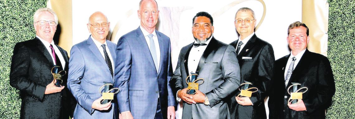 Hardy Jackson (third from right) along with other employees at Textron Systems receives an award for their outstanding contributions to the company.