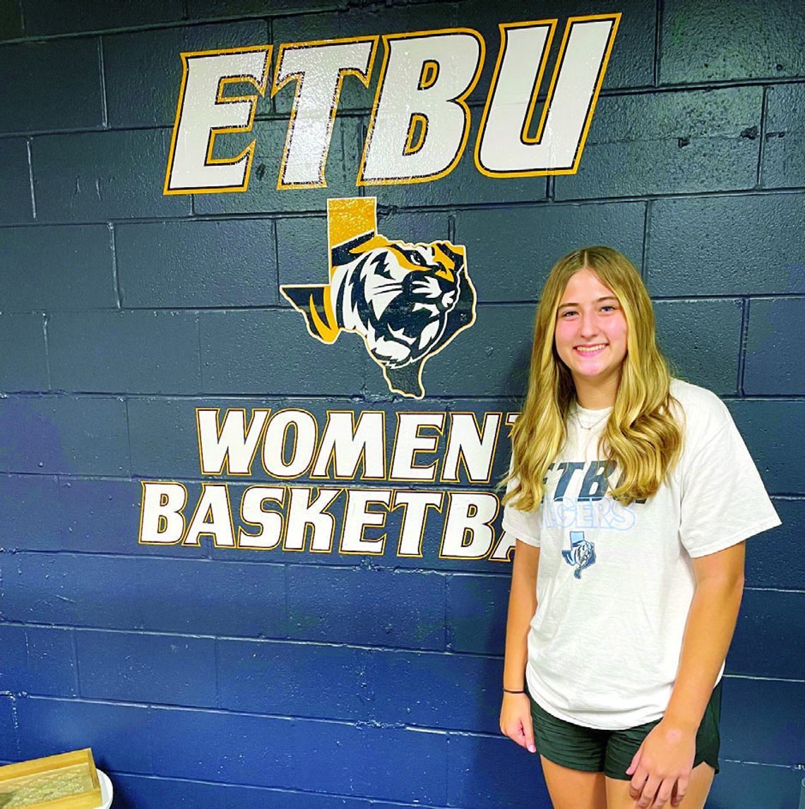 Taylor High School senior Ansley Reed happily poses for a photo over the weekend at the East Texas Baptist University women’s basketball facility in Marshall. Courtesy photo