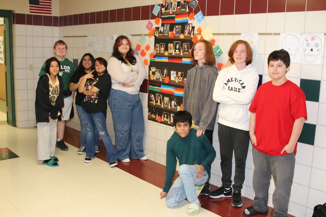 Students in Griselda Villalobos’ Spanish class at Taylor Middle School prepared a Day of the Dead altar in the hallway, including photos of icons and family members who have passed. Photo by Tim Crow