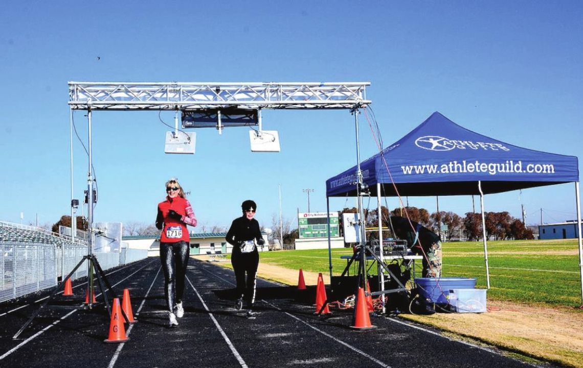 Coral and Donna Noonan cross the finish line together at the Run for the Roses 5K in Taylor Jan. 23, 2016. File photo