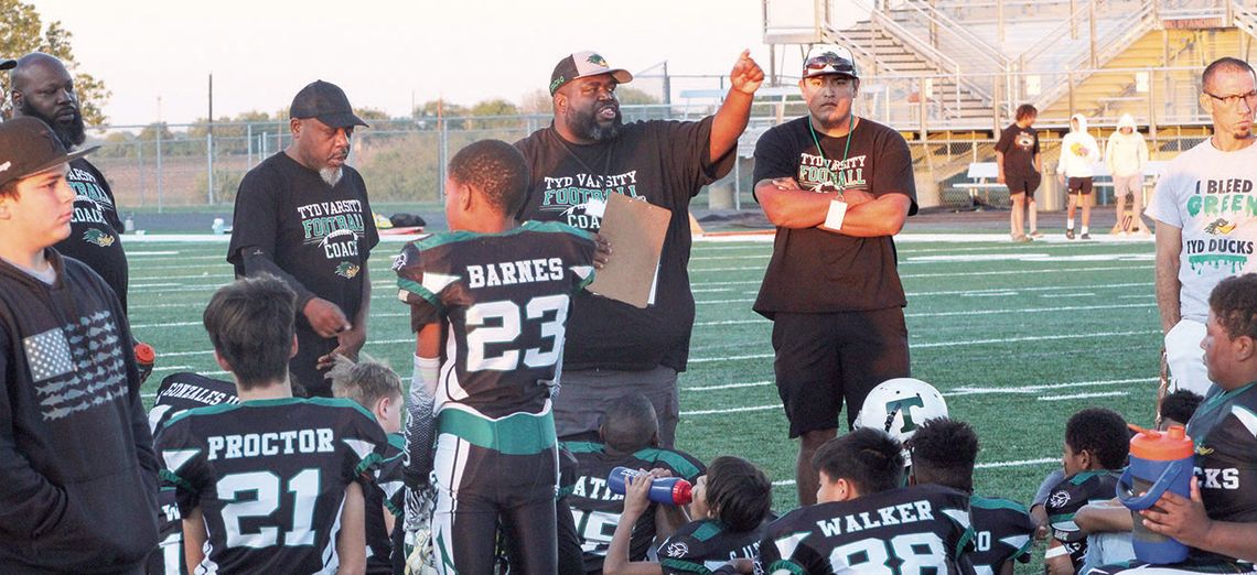 This past November, during the Tri-County Youth Football League Super Bowl, Quincy Griffin motivates and encourages his team. Photo by Evan Hale