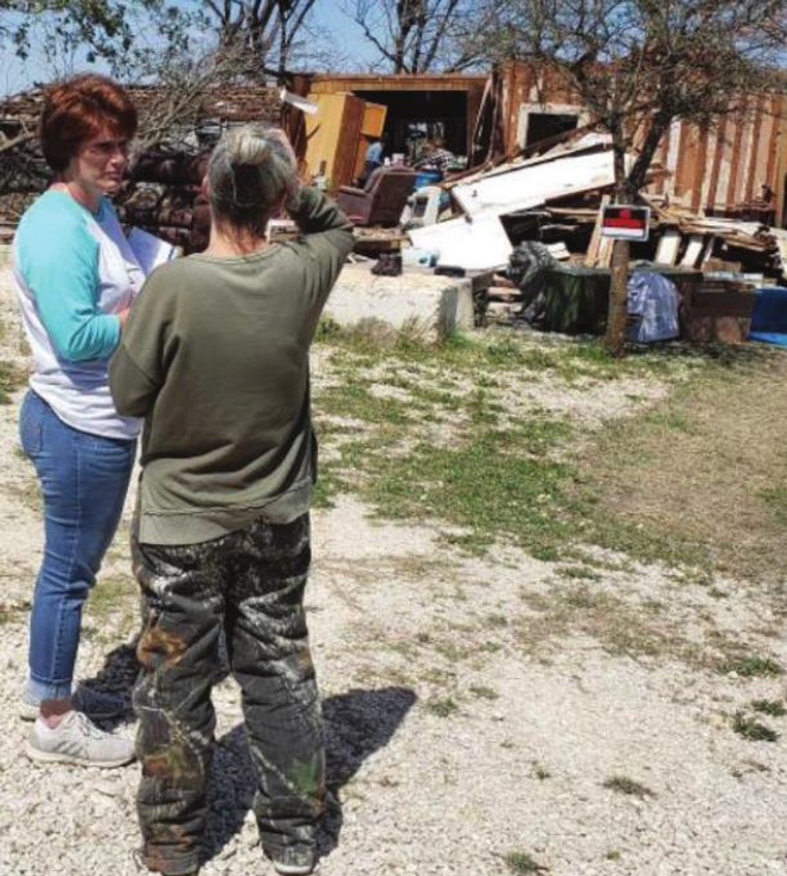 Stacy Stork, Salvation Army Taylor Service Unit chairman, talks with a local tornado victim in the days after the March 21 storm. Courtesy photo