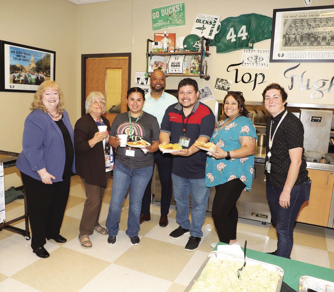 Michele Glaze, Director, Corporate Affairs, Samsung (far left), and Wesley King, Community Affairs Specialist, Samsung (far right), visit with Taylor High School staff during an appreciation luncheon sponsored by Samsung. From left are Michele Glaze, Suzanne Morris, Vanessa Villarreal, Mat...