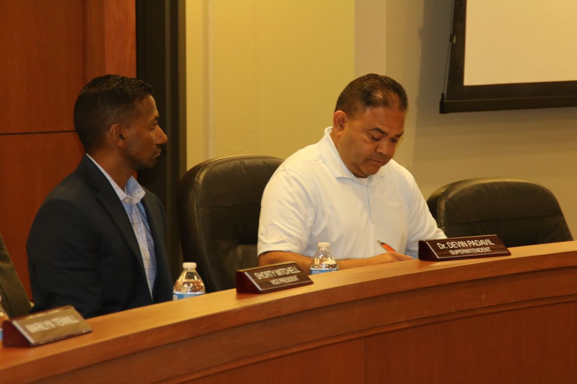 Superintendent Devin Padavil and board president Marco Ortiz discuss items during a special called meeting of the Taylor ISD board of trustees in Taylor May 31. Photo by Jason Hennington