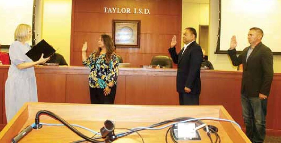 Vicki Roth (left) administers the oath of office for returning and new Taylor ISD board members Cheryl Carter, Marco Ortiz and Joseph Meller during the board’s meeting in Taylor May 16.