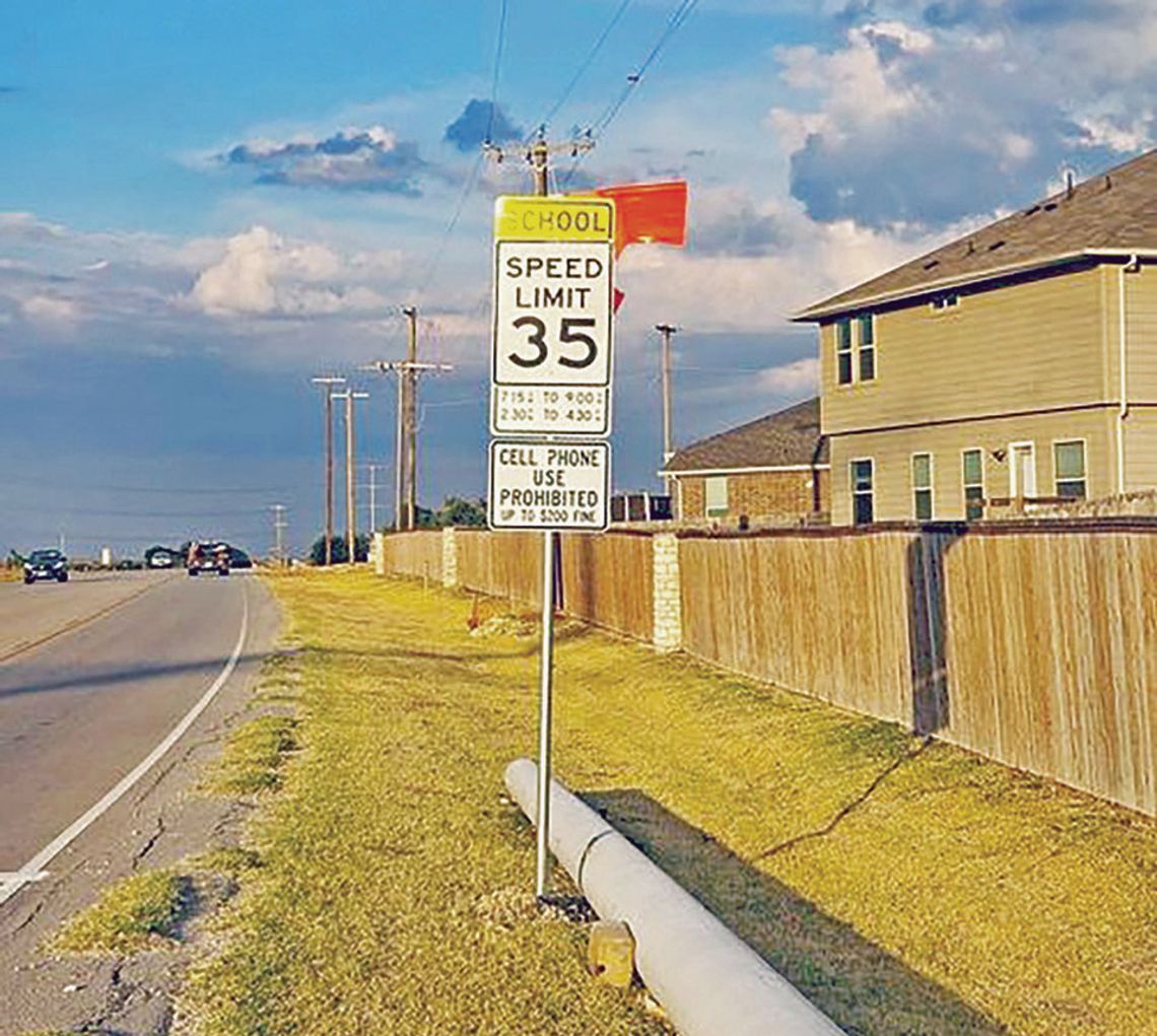 Orange flags alert drivers to a new school zone added along Limmer Loop in Hutto. Facebook / City of Hutto, Texas - Municipal Government