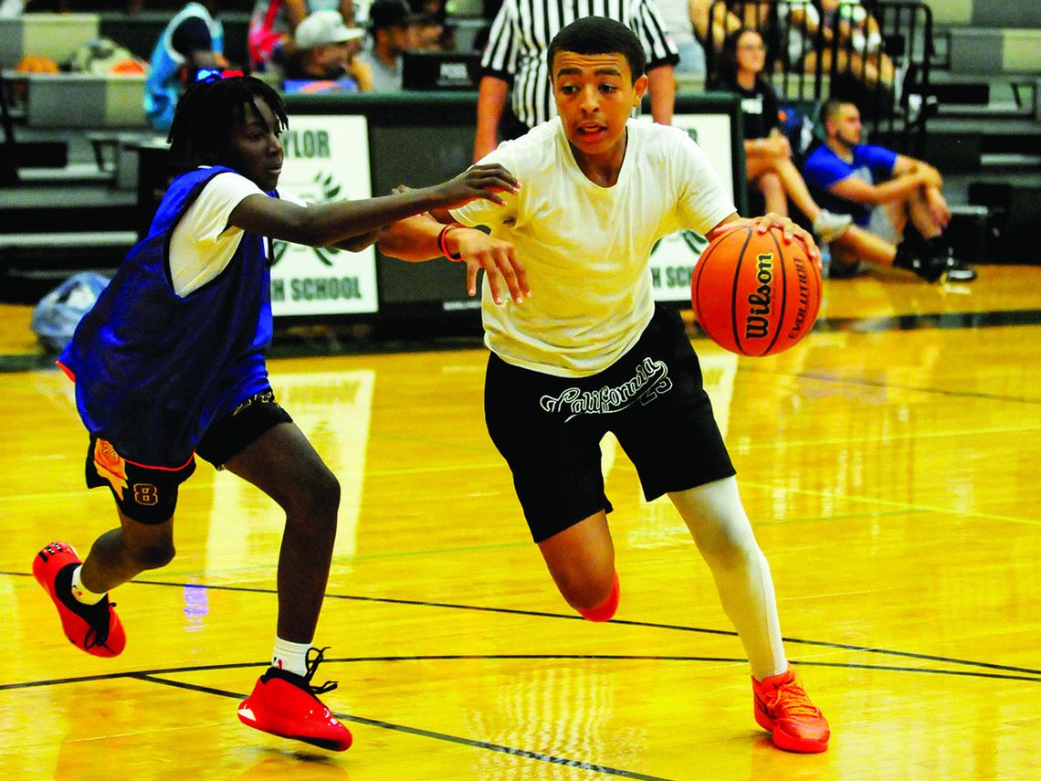 Lightning Bombers player Markell Fitzgerald gets around a defender and attacks the paint on Sunday, July 9 during an 11–14 division game. Photos by Larry Pelchat