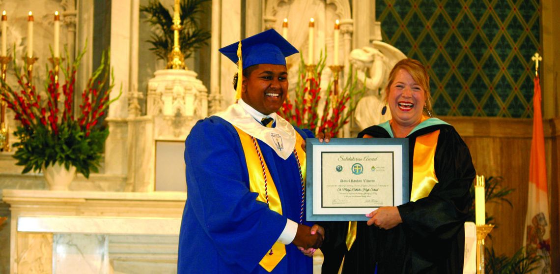 Salutatorian Daniel Vincent recieved his Salutatorian Award from Head of School Heidi Altman with a handshake and a chuckle at the Class of 2023 Commencement Ceremony Thursday, May 25, at St. Mary of the Assumption Catholic Church.