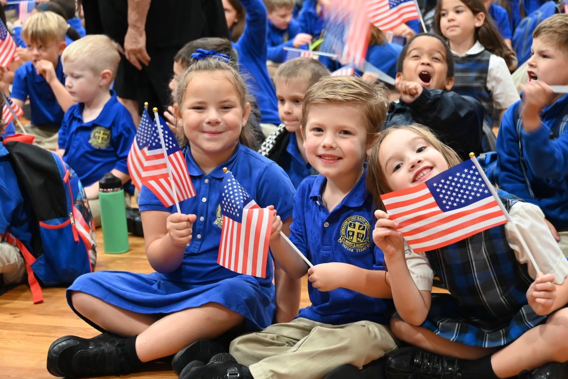 St. Mary’s Kindergarten students Stormy Lynch, James Friesenhahn and Amelia Hammans enjoy the Veteran’s Day ceremony. Courtesy photo