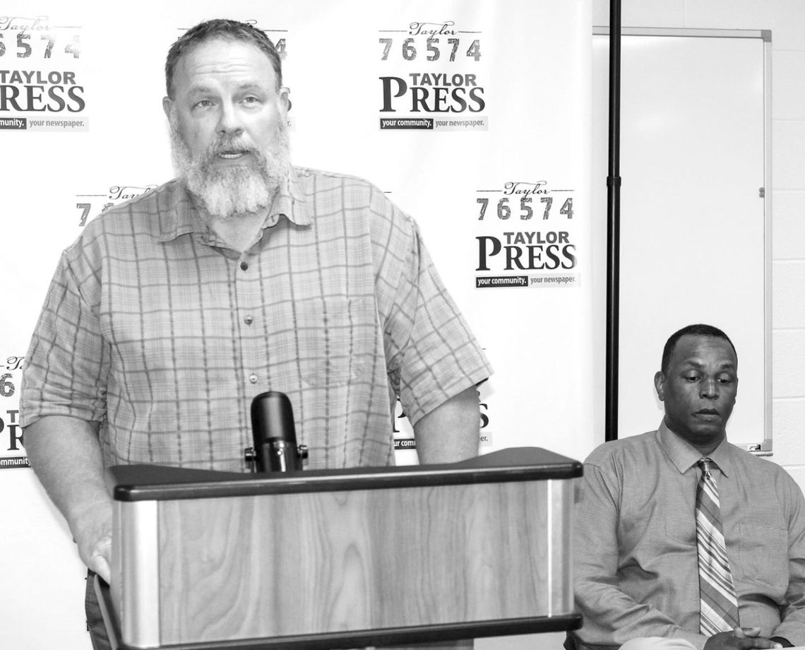 Gerald Anderson (right) watches as Stan Werner addresses the community during the candidate forum held April 12. Photo by Fernando Castro