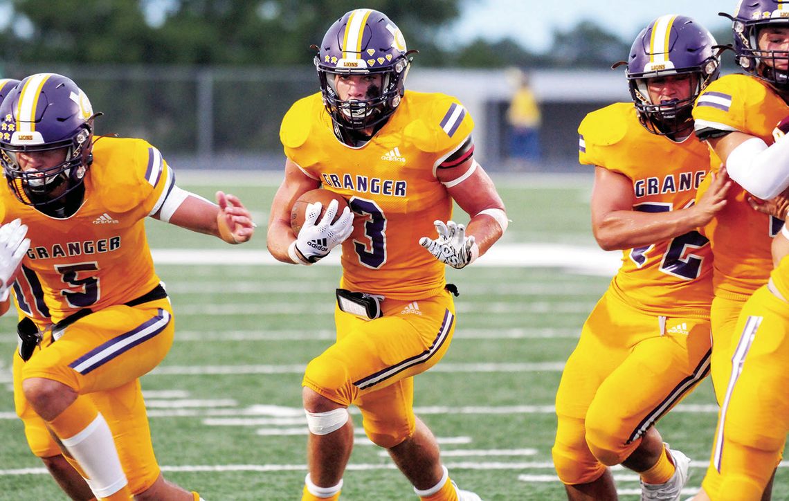 Lions’ senior DJ McClelland runs through a big hole to pick up extra yards. Photo by Larry Pelchat