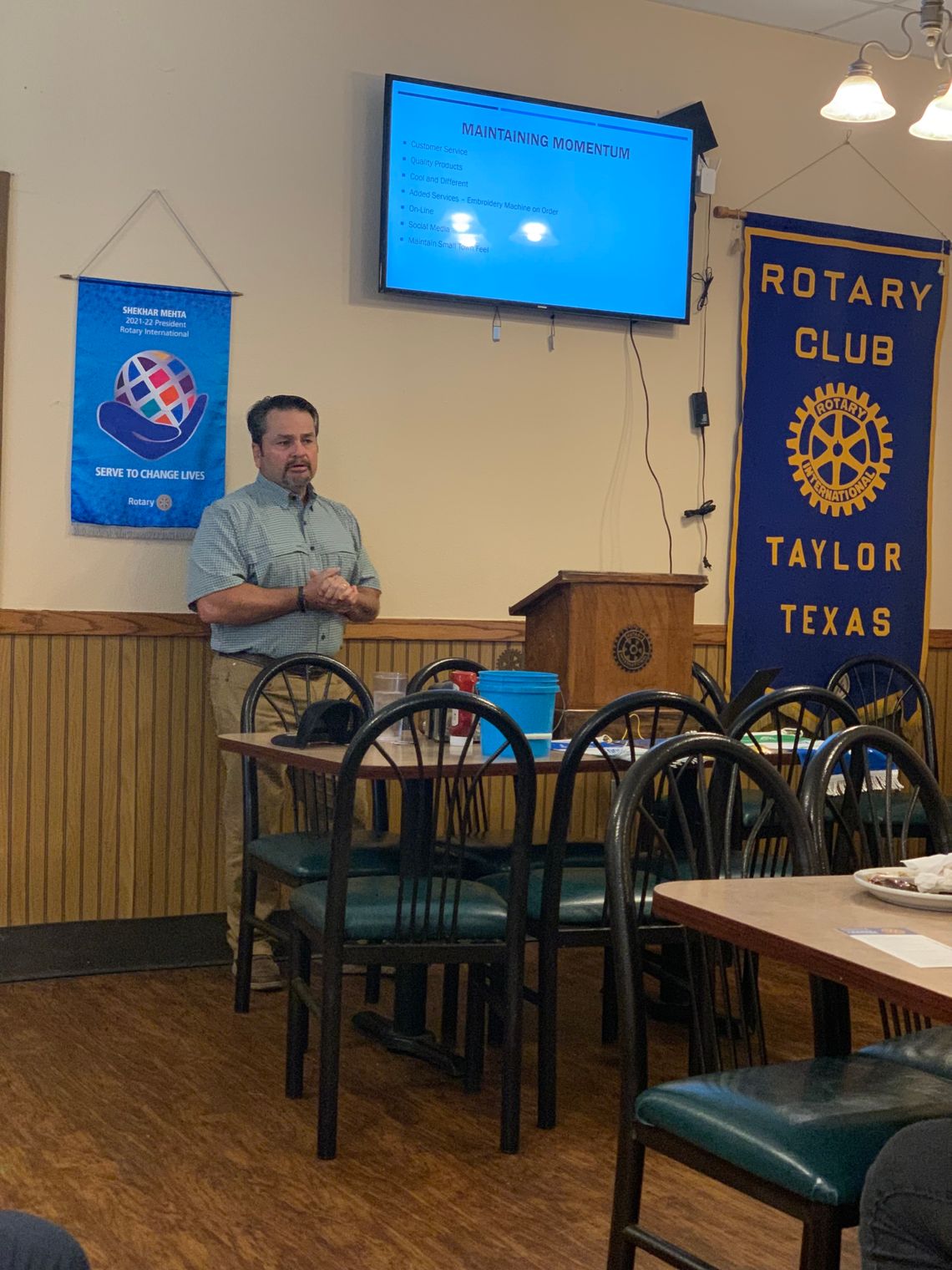 STORE OWNER TALKS TO ROTARY