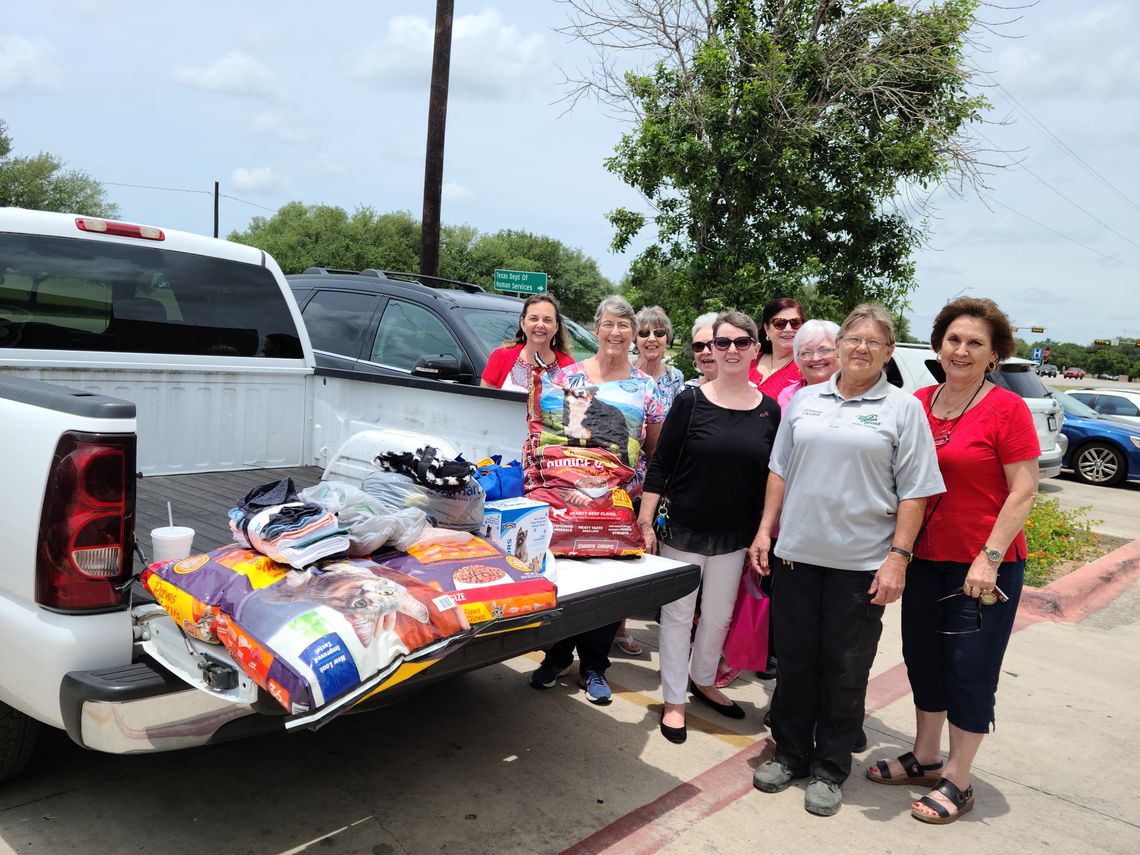 Sandy Perio (front), Taylor Animal Shelter manager, accepts donations from the Taylor Area Businesswomen.   Courtesy photo