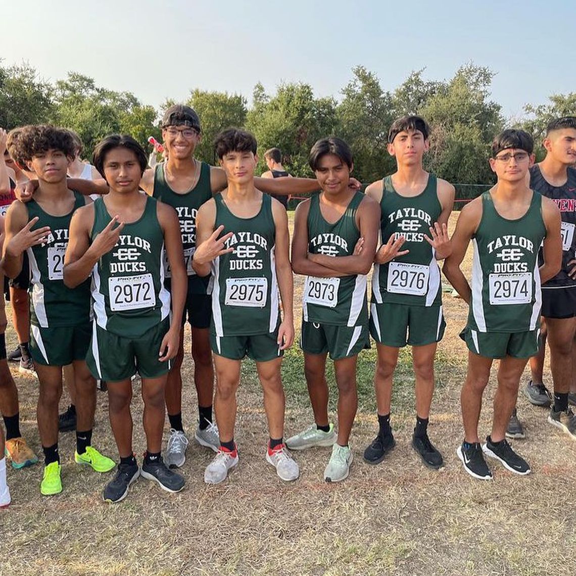 The Taylor High School boys varsity cross country team happily gathers together for a photo on Friday morning during the Vista Ridge Invitational meet held in Cedar Park. Photo courtesy of Taylor Athletic Booster Club. 