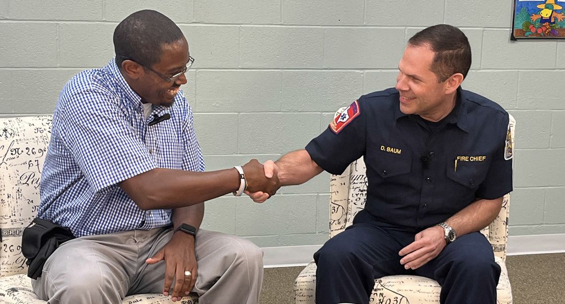 Taylor Fire Chief Daniel Baum (right) is welcomed with a handshake by Area Editor Jason Hennington. Photo by Grace Horvath