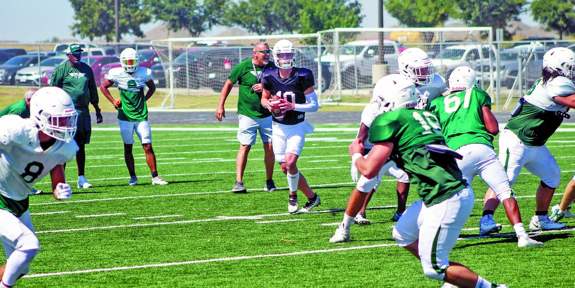 Taylor High School varsity football senior quarterback Joshua Mikulencak reads the defense and looks for an open receiver downfield on Saturday, Aug. 5 during the Duck Day scrimmage held at The Duck Pond.