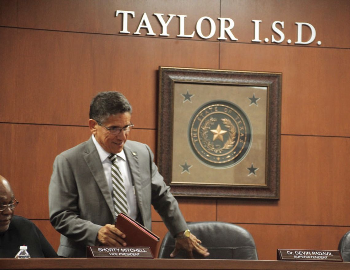 Steve Flores, who was named as the interim superintendent at the Aug. 7 special school board meeting of the Taylor Independent School District,, ceremoniously joins the trustees. Photo by Hunter Dworaczyk