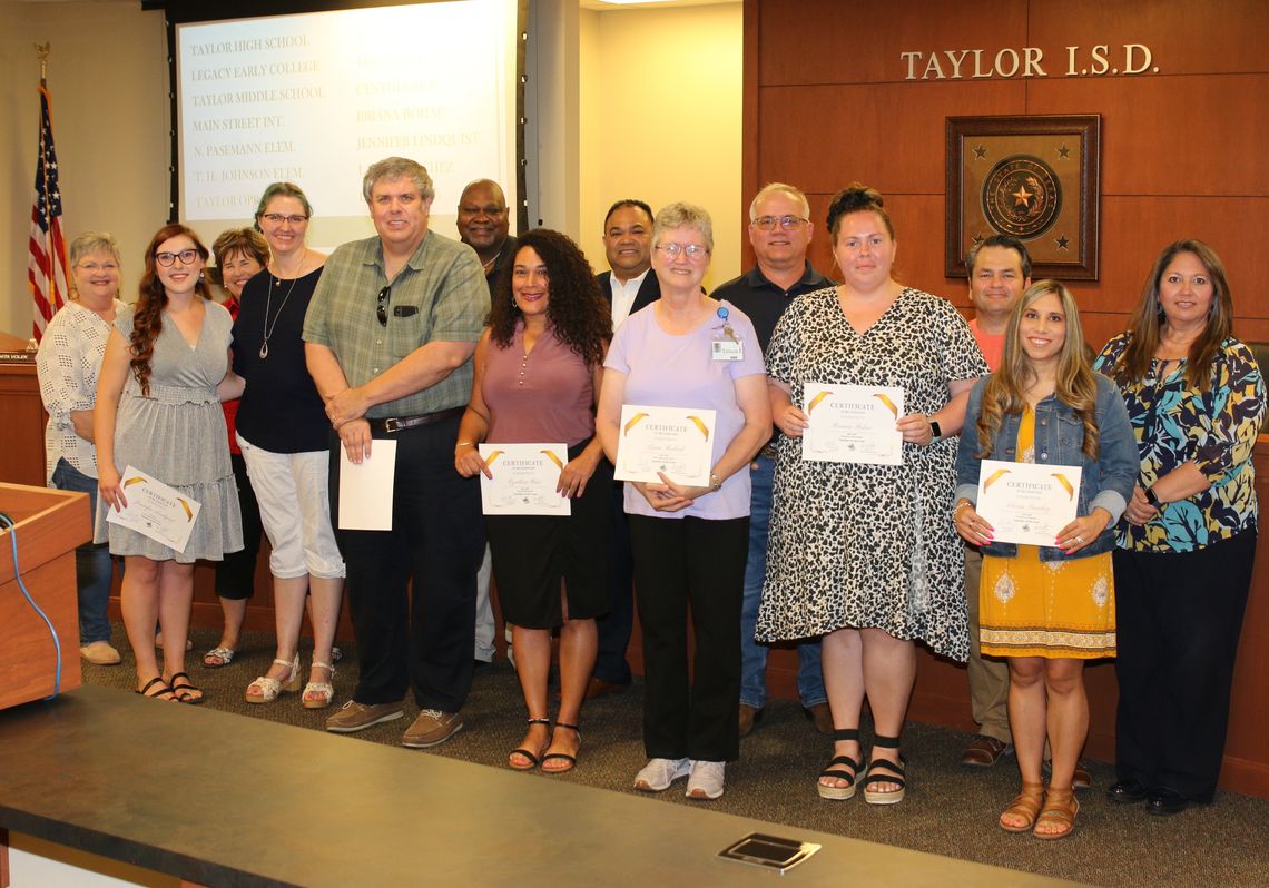 Taylor ISD school board members congratulate the district’s Teachers of the Year. Award recipients from left are Jennifer Lindquist, Jean Barnett, Trent Whitney, Cynthia Rios, Lynn Bedard, Briana Bohac and Laura Sanchez. Photo by Tim Crow