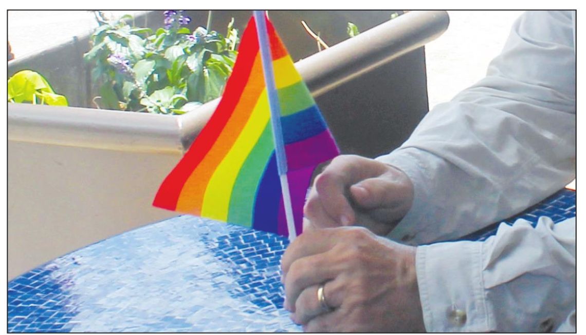 A resident holds a flag at the Taylor PRIDE event June 26, 2021. Photo by Fernando Castro