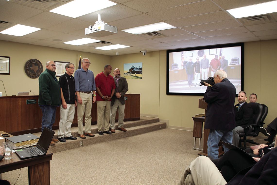 Former White House Photographer David Valdez shoots a photo of the Taylor City Council Oct. 27, at their regular meeting. Photo by Nicole Lessin