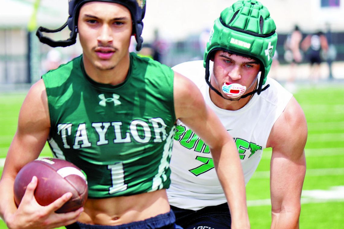 Taylor varsity football senior Kayden Land outruns an opposing player on Saturday during the Ducks’ 7-on-7 scrimmage against Burnet.