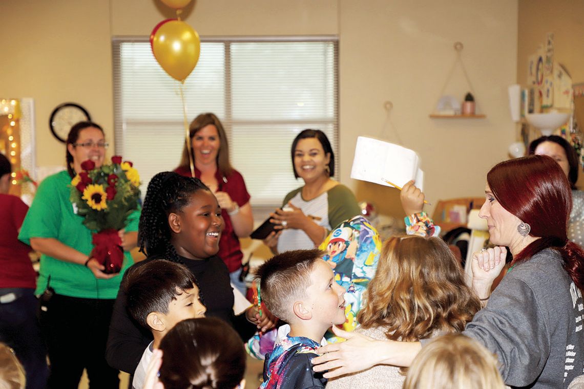 Naomi Pasemann Elementary Teacher of the Year, Jennifer Tobler (far right) is congratulated on her award by her students. Photo by Tim Crow