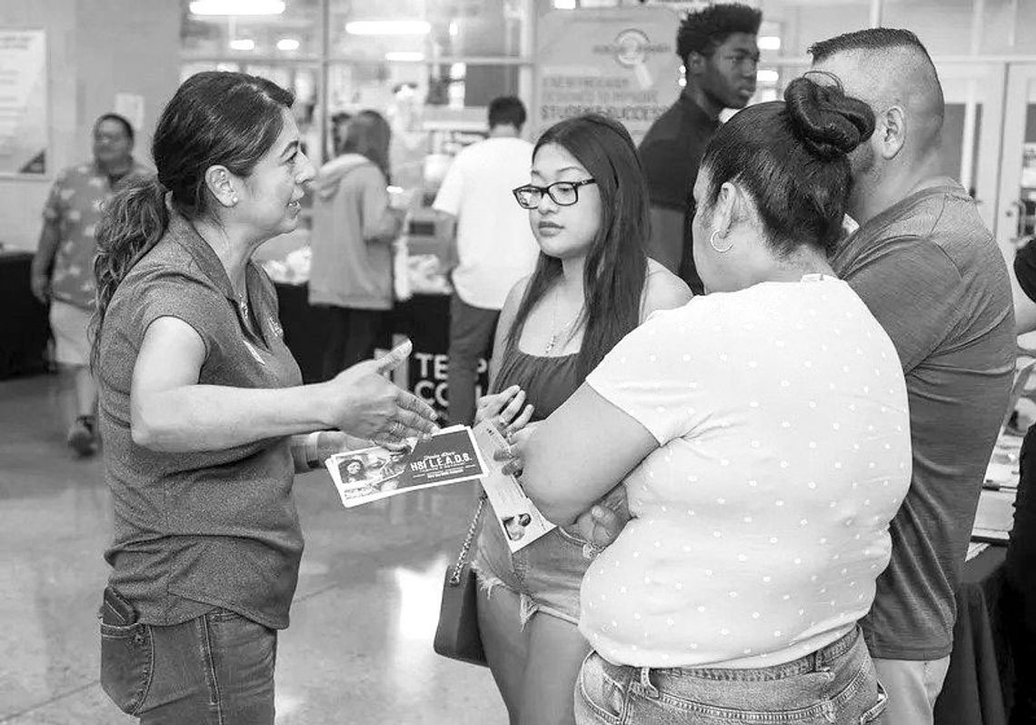 Dr. Eva Munguia, executive director of student success and HSI STEM program director, assists students and their families during the 2022 Open House in Hutto. Photo by Steve Lemmons