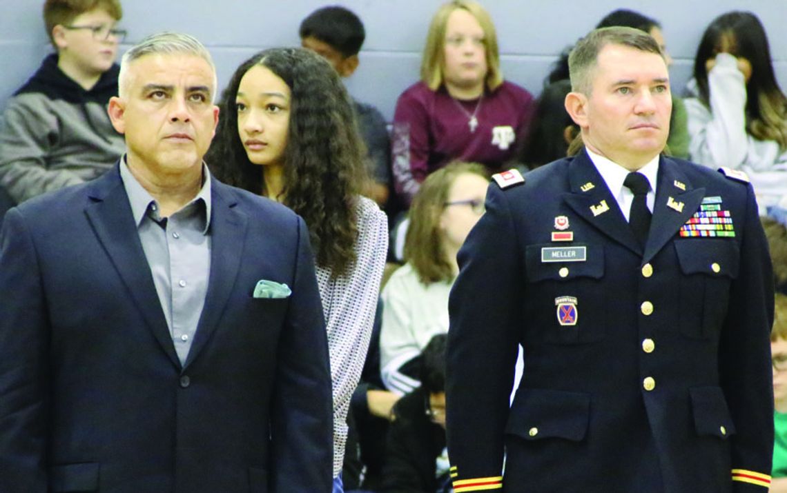 Taylor ISD teacher Armando Talavera (left) and school board member Joe Meller are recognized during the Taylor Middle School Veterans Day tribute. Photo by Jason Hennington