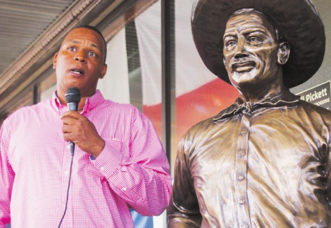 Gerald Anderson stands next to a statue of his great uncle Bill Pickett and thanks the community for the support to finally have the statue placed in downtown.