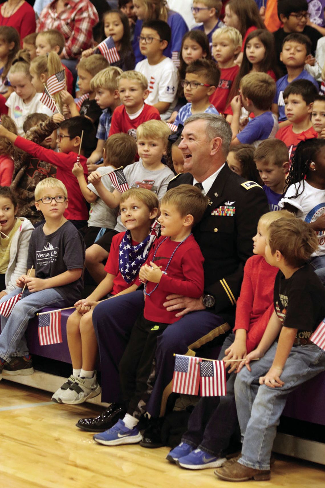 Students sit with Wesley West during the Veteran’s Day celebration at Thrall ISD.