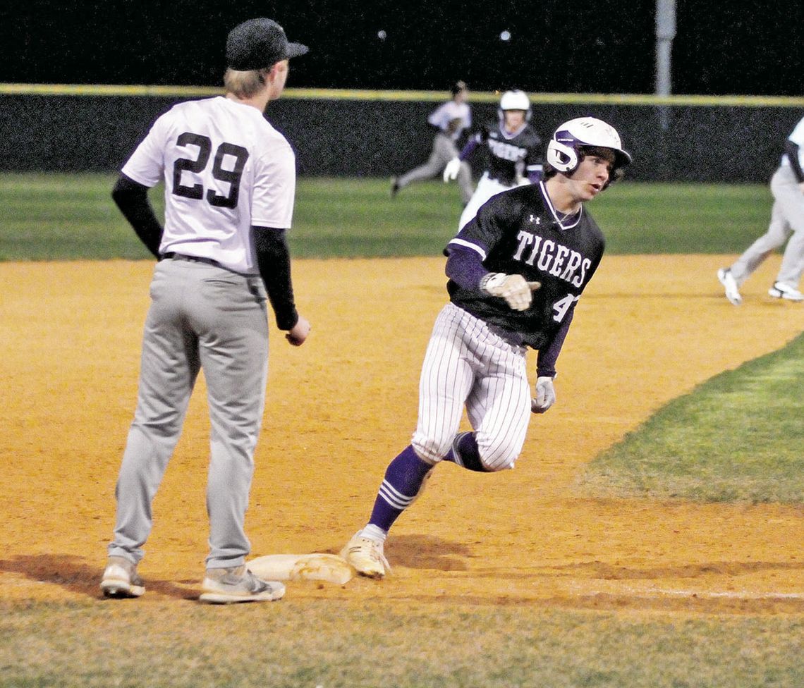 Asa Gibbs rounding third base on his way to adding a point on the score board for his team. Photo by Larry Pelchat