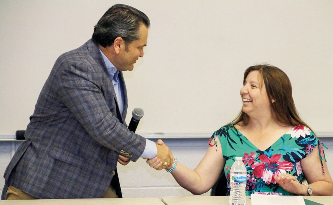 Jim Buzan (left) shakes hands with his opponent Lisa Baum after the candidate forum hosted by the Taylor Press and the Greater Taylor Chamber of Commerce.