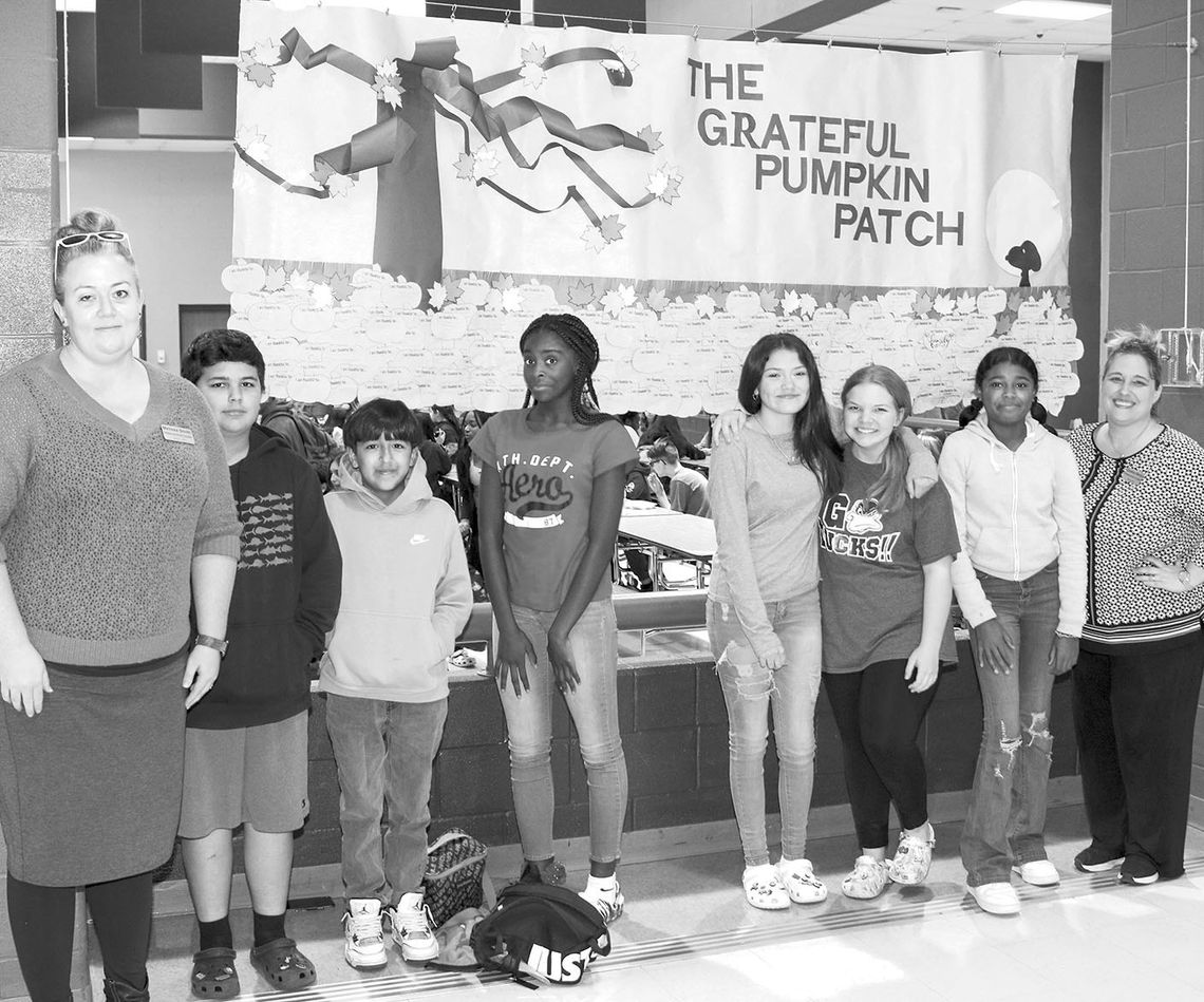 Taylor Middle School Counselors and a few seventh-grade students take a moment from reading notes of gratitude written by classmates and colleagues to take a photo with the display. From left are Counselor Melissa Smith, Santiago Hall-Albavera, Andrew Hernandez, Amerius White, Trinity Kell...