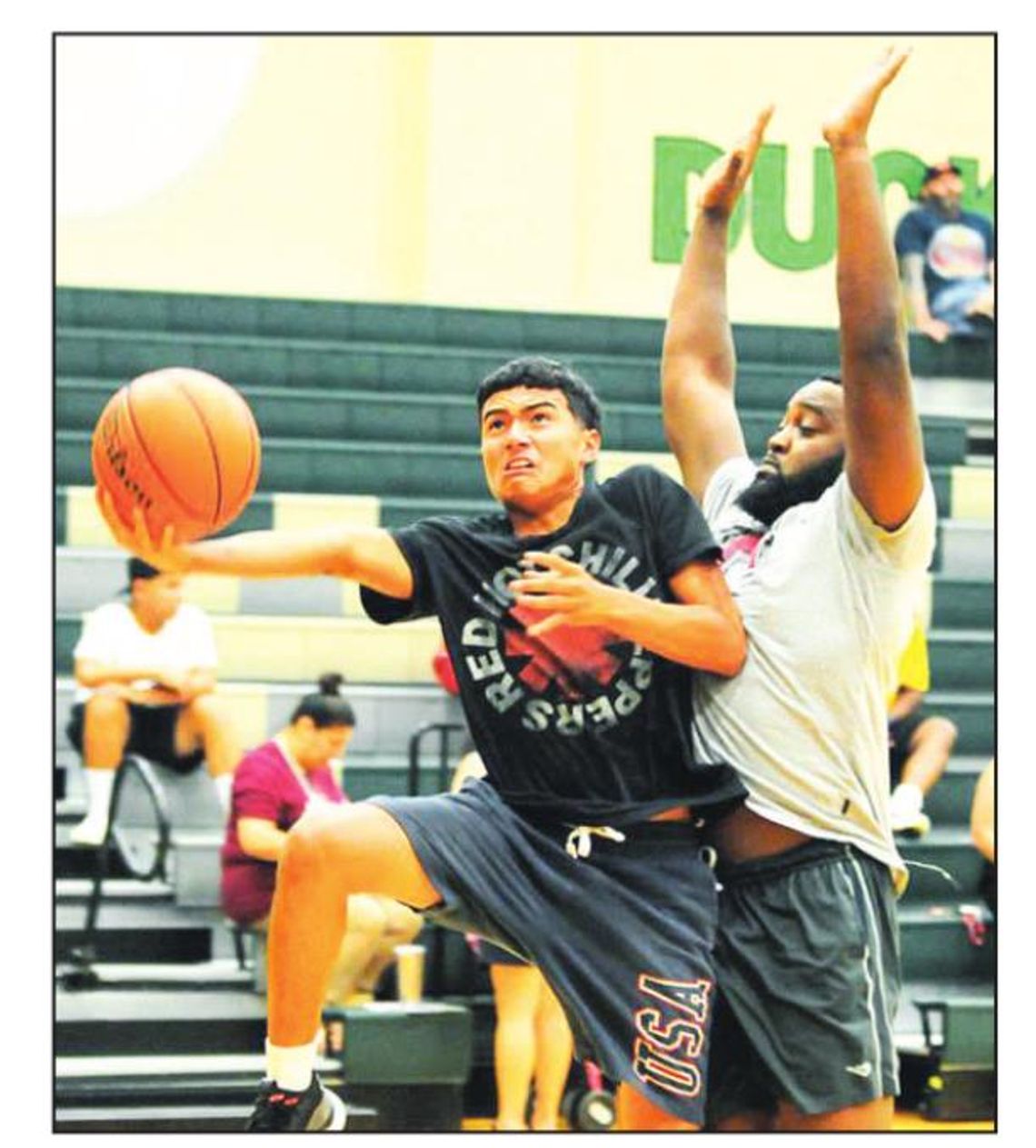 Anthony Baron goes up past Cordez Maddox in a game at last year’s Taylor Press 3-on-3 Basketball Tournament. Photo by Larry Pelchat