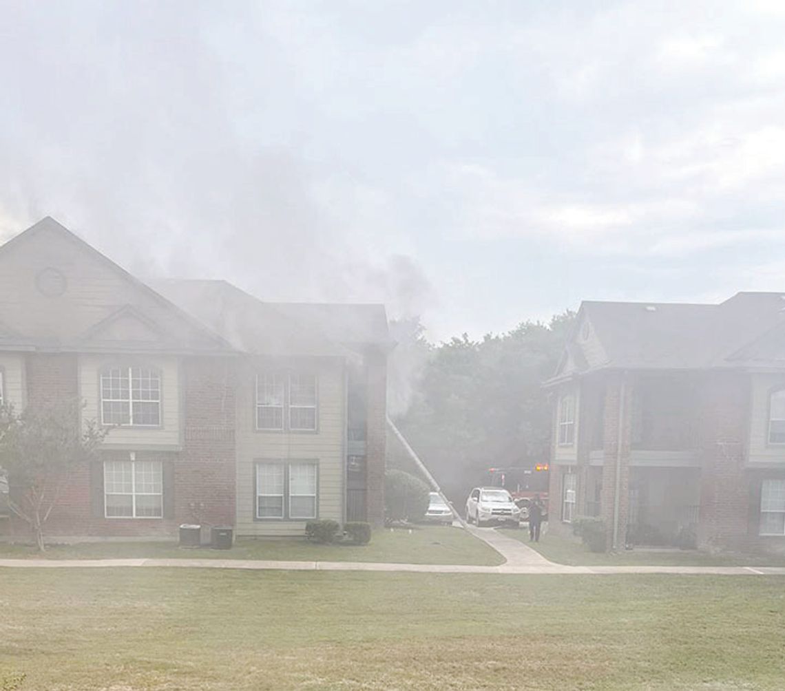 The lower floor of Building 3 sustained extensive water damage during a fire at the Burnett Place Apartments Monday. Firefighters using a ladder rescued two residents and no injuries were reported. Courtesy photo