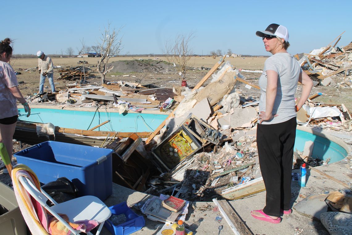 Sharrion Threadgill looks over some of the remains of her Granger-area home March 24, three days after a tornado tore through their family’s home. Photo by Fernando Castro