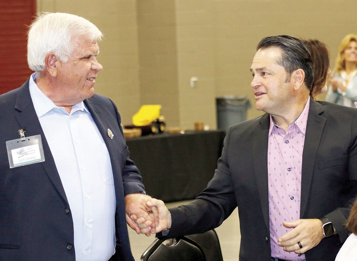 Jim Buzan (right) congratulates Sam Dowdy as he heads to the front to accept the Rotary Citizen of the Year award. Photos by Jason Hennington