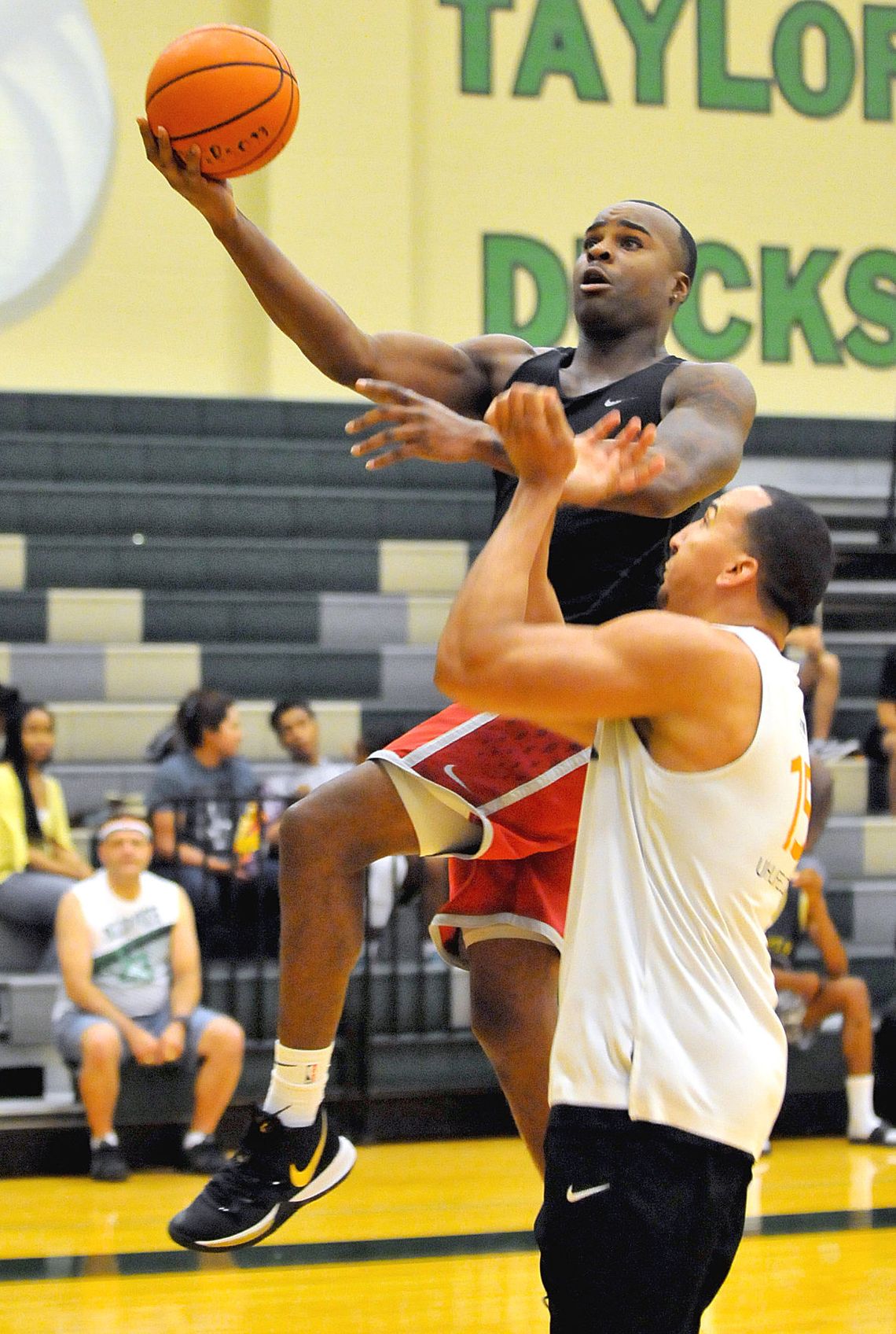 Chuck Okpalaeze (left) goes for a layup in the championship game of the Taylor Press 3-on-3 Basketball Tournament July 14, 2019. The Tournament returns this summer. Call 512-352- 8535 for more information. Photo by Larry Pelchat