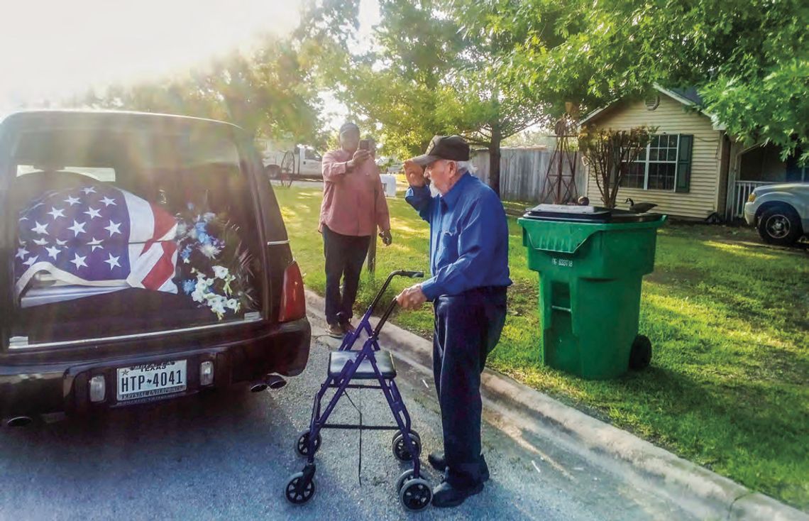 John Gipson (back) takes a photo as Espirririon “SP” Santa Cruz salutes a fellow member of the military who served in the Korean War, a conflict Santa Cruz also served in. Courtesy photo