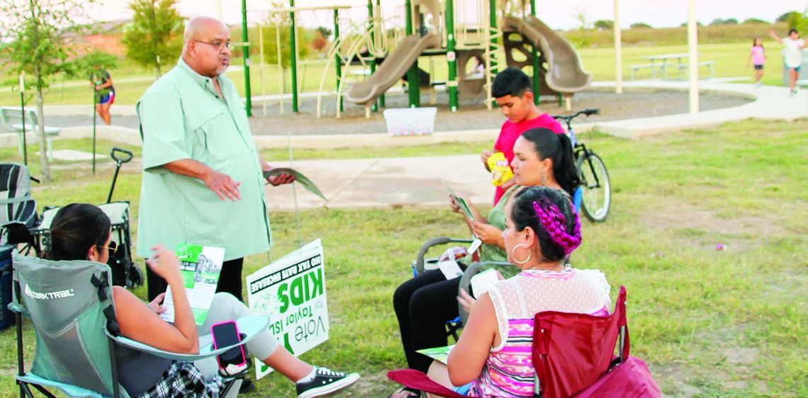 Former Taylor Independent School District trustee Thomas Martinez, a member of the Citizens for Taylor ISD Political Action Committee, talks with parents about the bond issue Oct. 4 at a celebration for National Night Out at the Avery Glen subdivision. Residents used grassroots organizing...