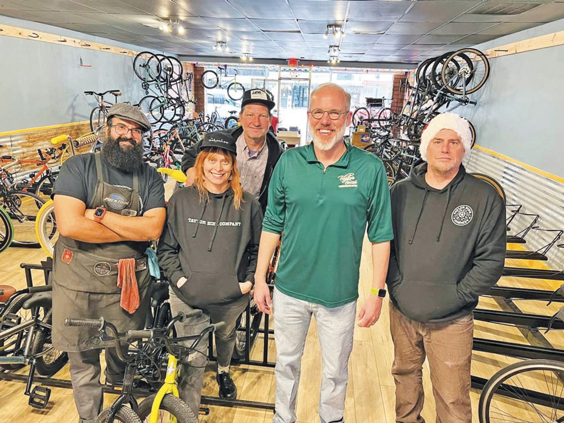 (From left) Eddie Chavez, Shannon Chavez, Vytis Vardys, Mayor Brandt Rydell and John Chisholm take a moment to pose together Dec. 16 at Taylor Bike Co. Photo courtesy of Brandt Rydell