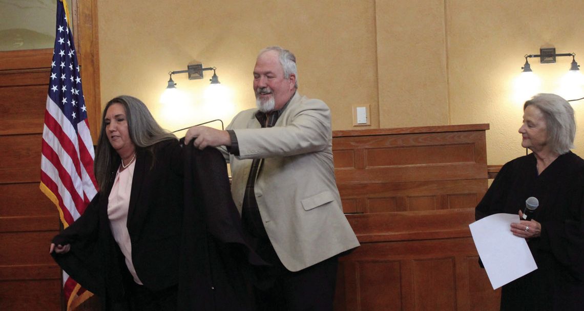 Rhonda Redden puts on her new judge’s robe with the assistance of husband Greg as Judge Edna Staudt looks on during the swearing-in ceremony for Williamson County elected officials Jan. 1 at the Williamson County Courthouse. Courtesy photo