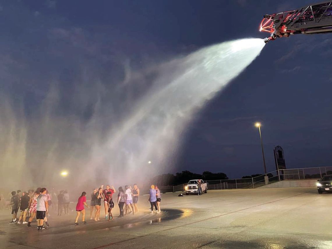 Taylor High School Band and Color Guard students celebrate the end of summer practice in the 100 plus degree heat with a visit from the Taylor Fire Department. Courtesy photo