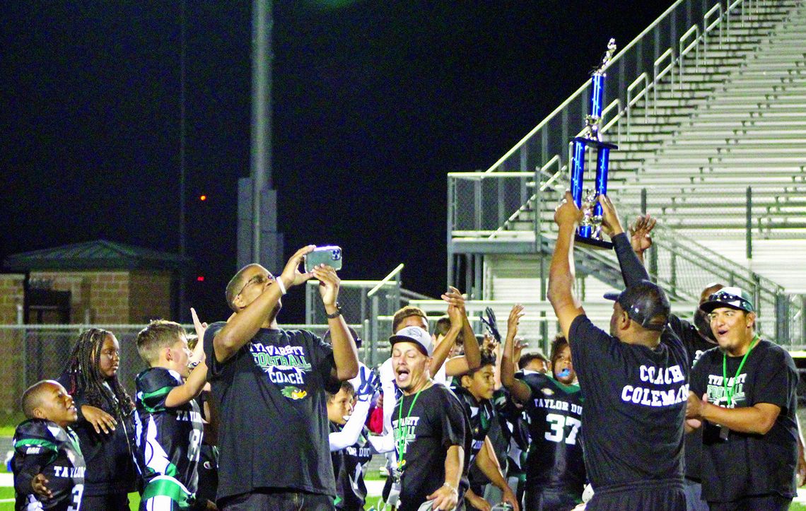 Youth Ducks’ coaches hold up the Tri-County Championship to celebrate with their team. Photos by Evan Hale