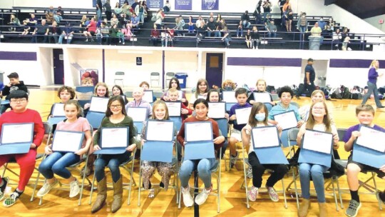 Thrall Middle School students show their certificates they earned upon graduation from the D.A.R.E. program in Thrall Jan. 14.