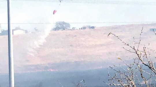 Travis County STAR Flight drops water on a brush fire in south Hutto Jan. 14. Photos by Lt. Mike Pendley