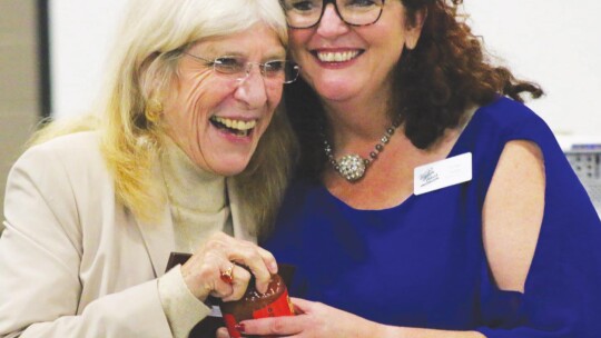 Tia Stone (right) recognizes outgoing chamber board member Nancci Phillips Burgess. All outgoing board members received a plaque and a jar of Ancira Salsa. Photos by Jason Hennington